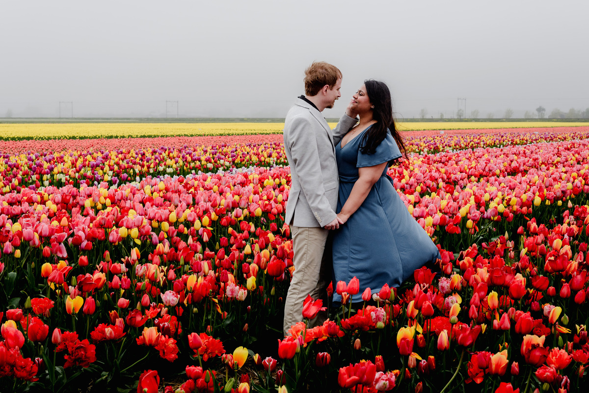 Tanya and Logan’s engagement photoshoot in the Netherlands' tulip fields started with a bike ride from Hillegom station. Despite the cold weather, we captured beautiful moments at The Tulip Barn, showcasing their love in stunning surroundings.