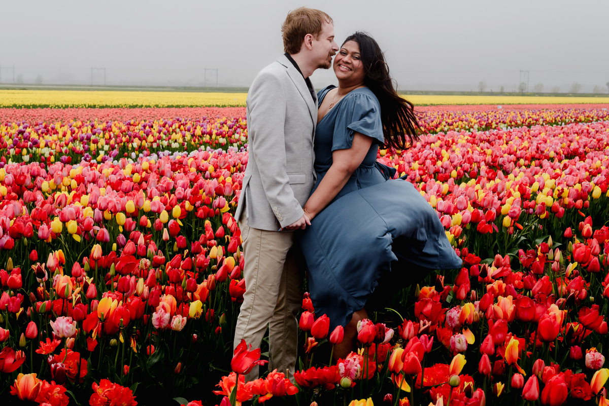 Tanya and Logan’s engagement photoshoot in the Netherlands' tulip fields started with a bike ride from Hillegom station. Despite the cold weather, we captured beautiful moments at The Tulip Barn, showcasing their love in stunning surroundings.