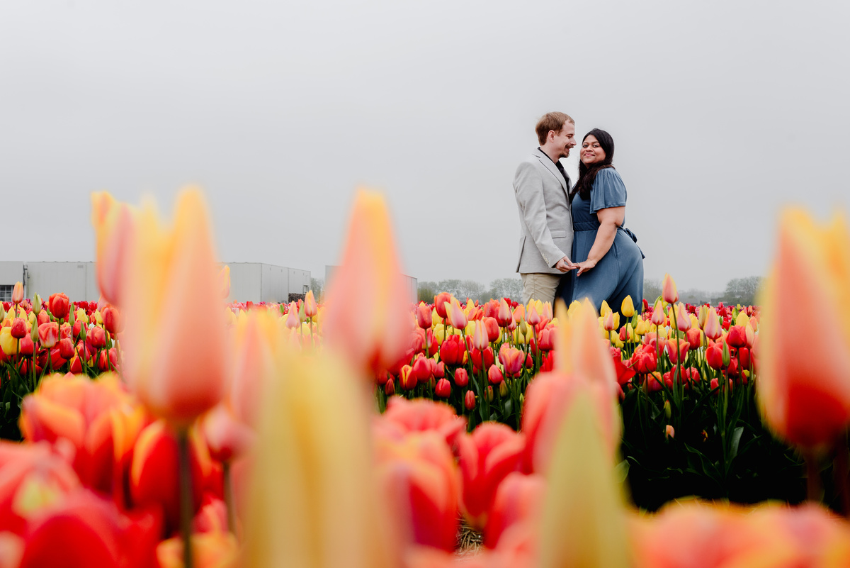Tanya and Logan’s engagement photoshoot in the Netherlands' tulip fields started with a bike ride from Hillegom station. Despite the cold weather, we captured beautiful moments at The Tulip Barn, showcasing their love in stunning surroundings.