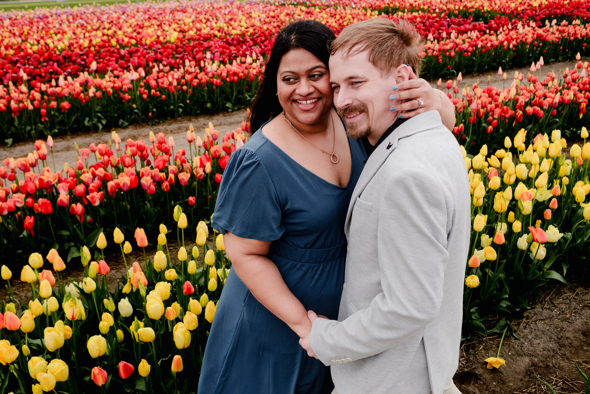 Tanya and Logan’s engagement photoshoot in the Netherlands' tulip fields started with a bike ride from Hillegom station. Despite the cold weather, we captured beautiful moments at The Tulip Barn, showcasing their love in stunning surroundings.