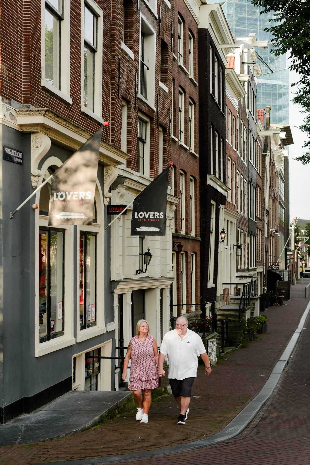 The couple posing in front of a 