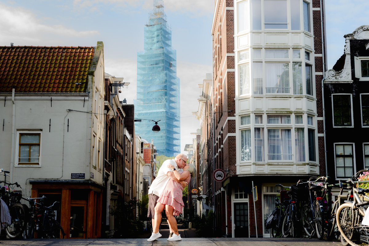  The couple dancing joyfully on the bridge, with the canal and bicycles adding to the charm of the scene.