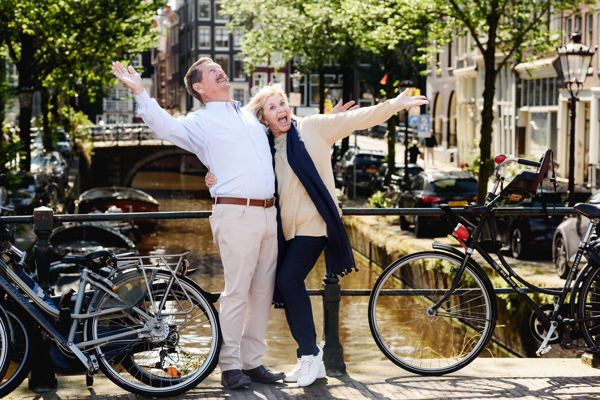 couple posing together on a picturesque Amsterdam street, enjoying a quiet moment. This is part of a family photo session in Amsterdam
