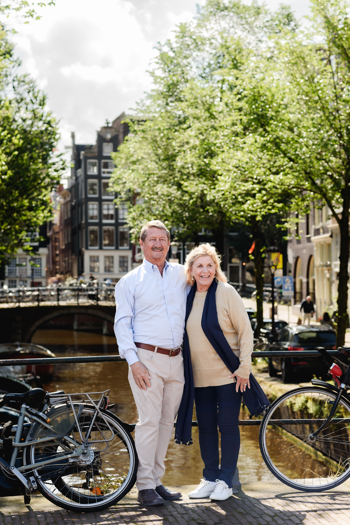 couple posing together on a picturesque Amsterdam street, enjoying a quiet moment. This is part of a family photo session in Amsterdam