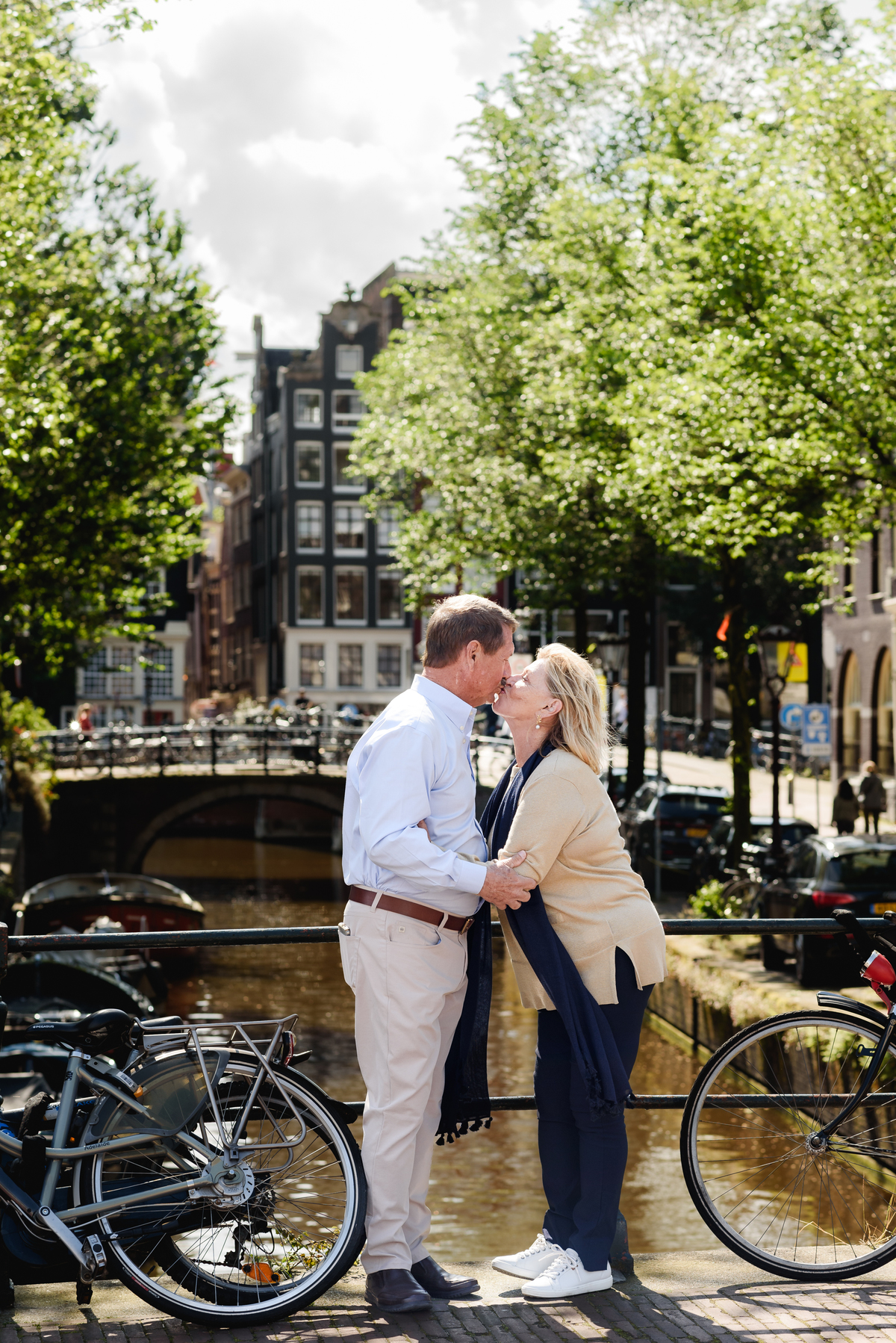 couple posing together on a picturesque Amsterdam street, enjoying a quiet moment. This is part of a family photo session in Amsterdam