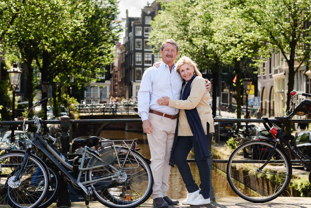 couple posing together on a picturesque Amsterdam street, enjoying a quiet moment. This is part of a family photo session in Amsterdam