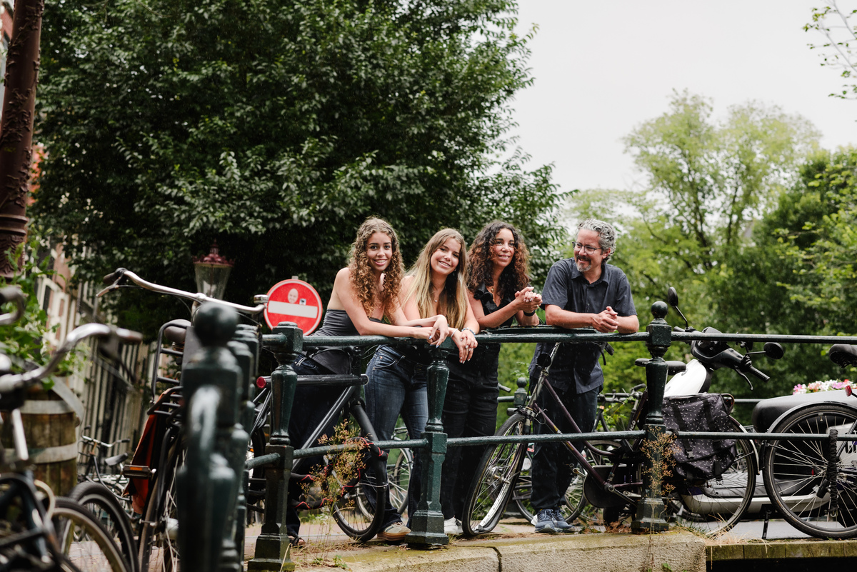 family photo session the the amsterdam canals in the Jordaan district, most famous. Family celebrating a wedding anniversary holding a famous Amsterdam cookie