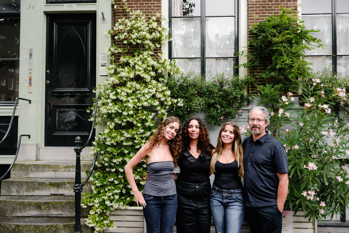 family photo session the the amsterdam canals in the Jordaan district, most famous. Family celebrating a wedding anniversary holding a famous Amsterdam cookie
