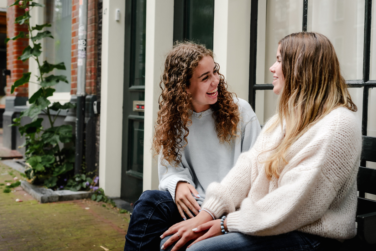 family photo session the the amsterdam canals in the Jordaan district, most famous. Family celebrating a wedding anniversary holding a famous Amsterdam cookie