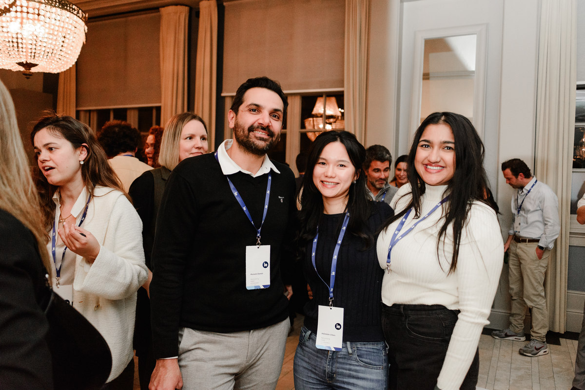A small group of alumni networking at the IE University event, representing the casual and professional vibe of the evening.