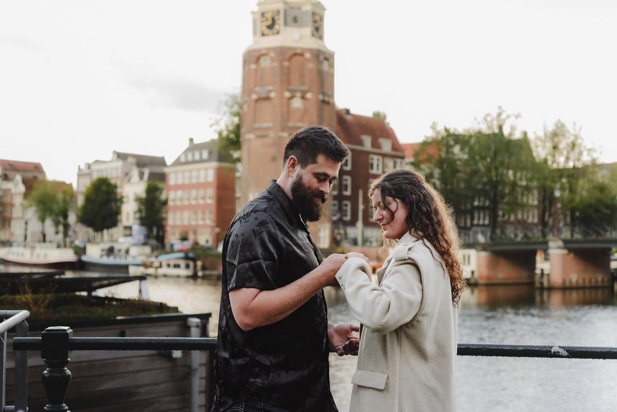 Close-up of the couple sharing a tender look against a backdrop of Amsterdam’s iconic brick walls, creating an intimate engagement photo.
