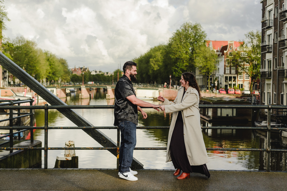 Close-up of the couple sharing a tender look against a backdrop of Amsterdam’s iconic brick walls, creating an intimate engagement photo.