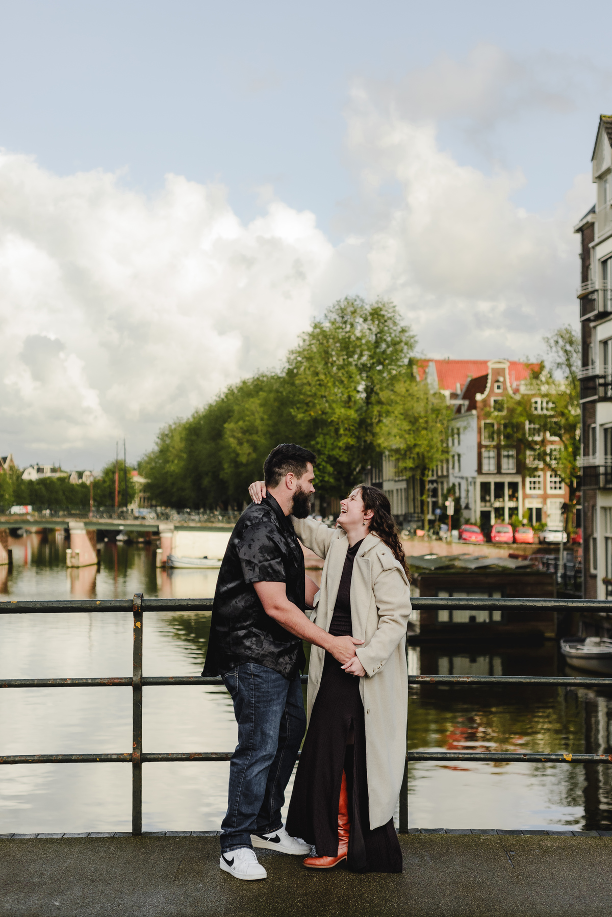 Close-up of the couple sharing a tender look against a backdrop of Amsterdam’s iconic brick walls, creating an intimate engagement photo.