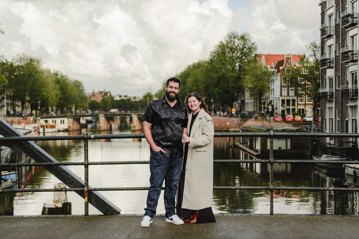 Close-up of the couple sharing a tender look against a backdrop of Amsterdam’s iconic brick walls, creating an intimate engagement photo.