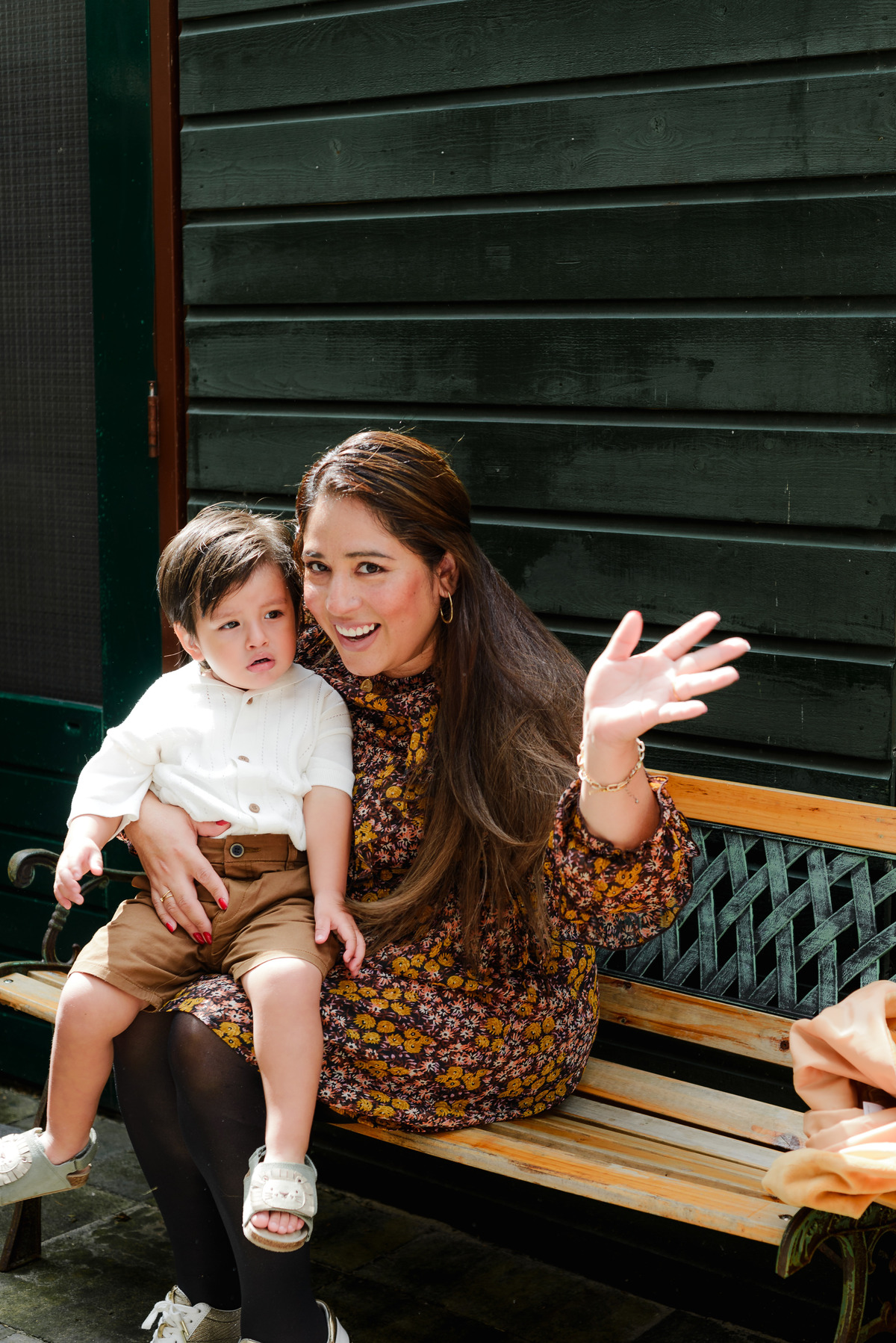 The family posing together in front of a jungle-themed photo backdrop, smiling as they celebrate the birthday boy’s special day.