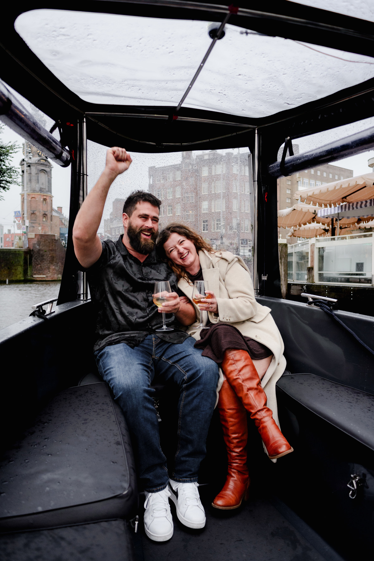 Behind-the-scenes shot of the photographer capturing a proposal from the boat’s deck, blending into the crew