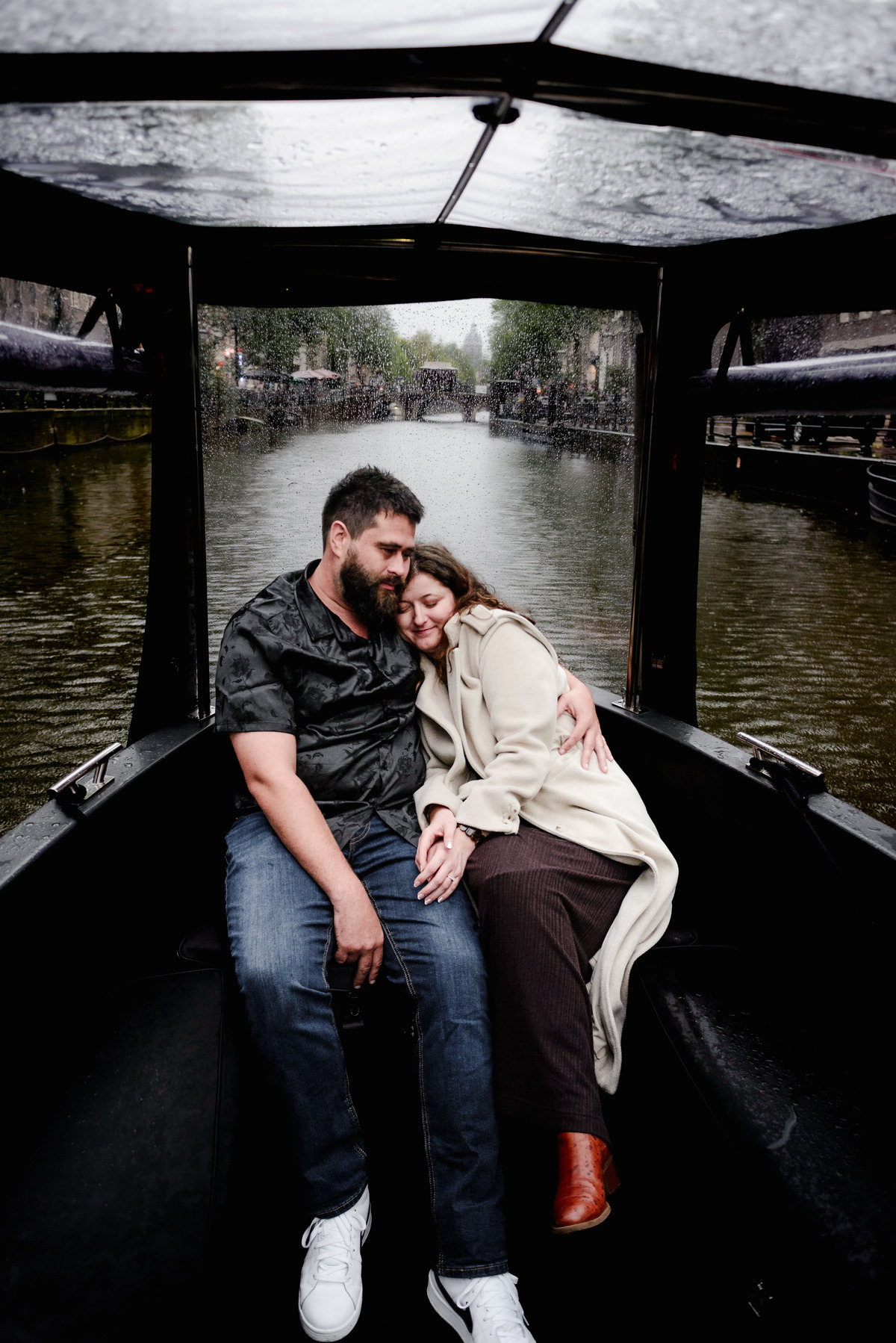 Behind-the-scenes shot of the photographer capturing a proposal from the boat’s deck, blending into the crew
