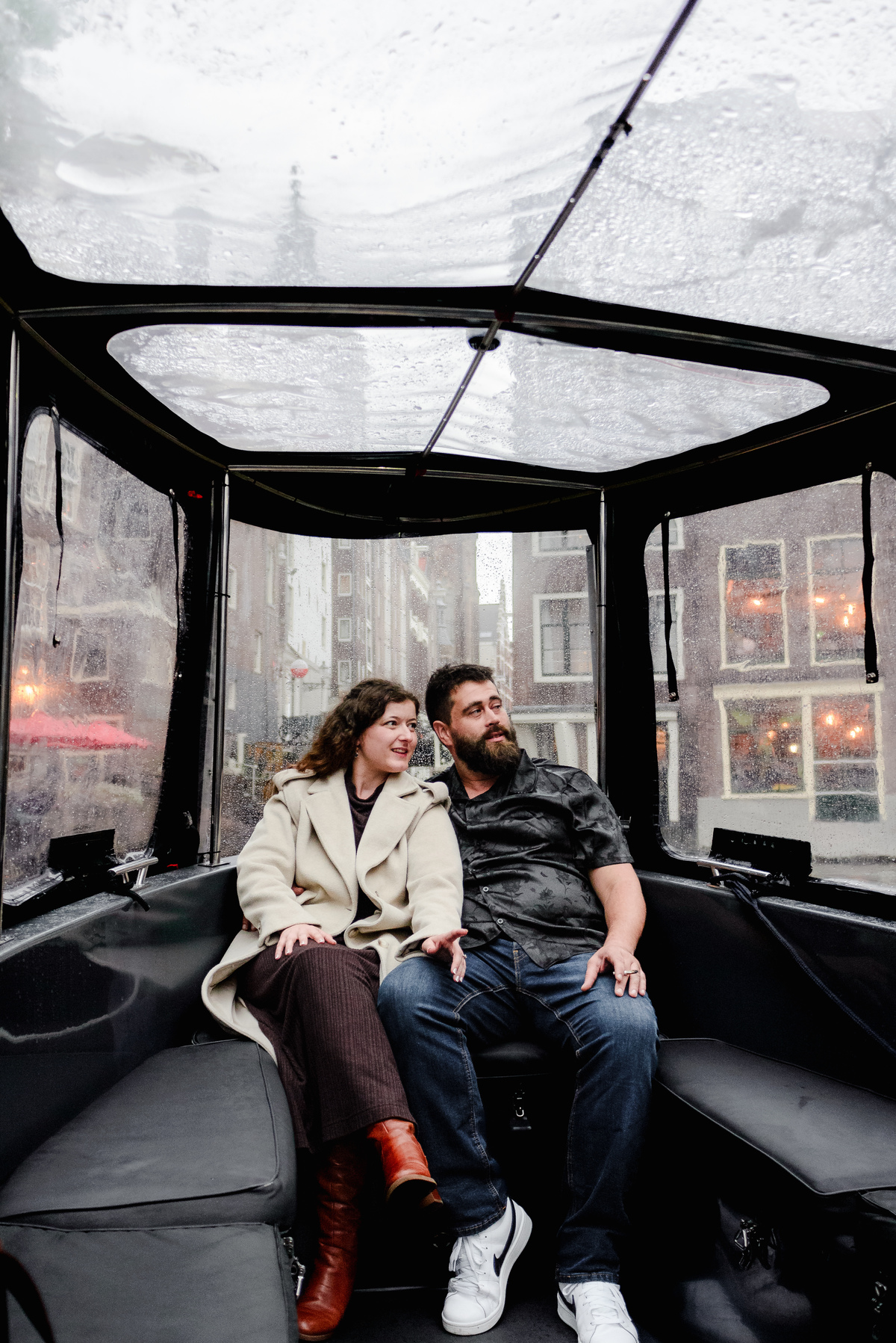 Behind-the-scenes shot of the photographer capturing a proposal from the boat’s deck, blending into the crew