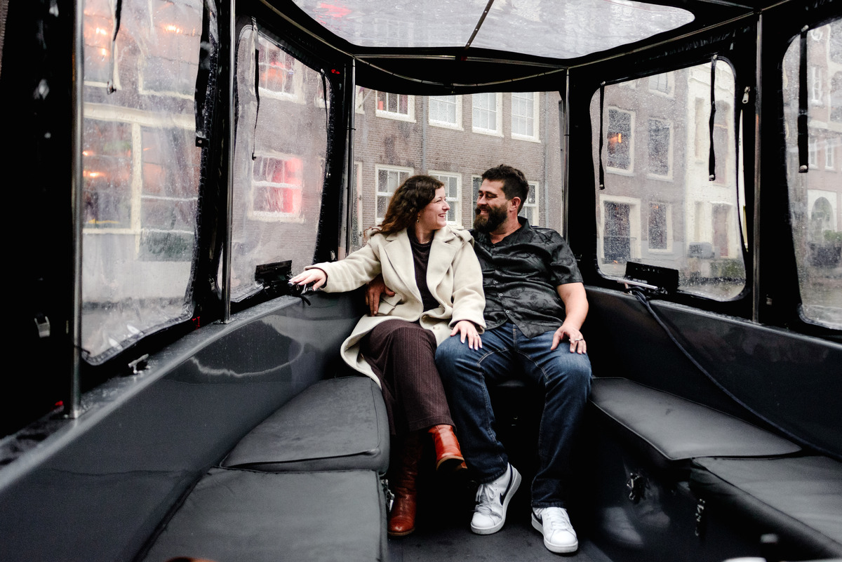 Behind-the-scenes shot of the photographer capturing a proposal from the boat’s deck, blending into the crew