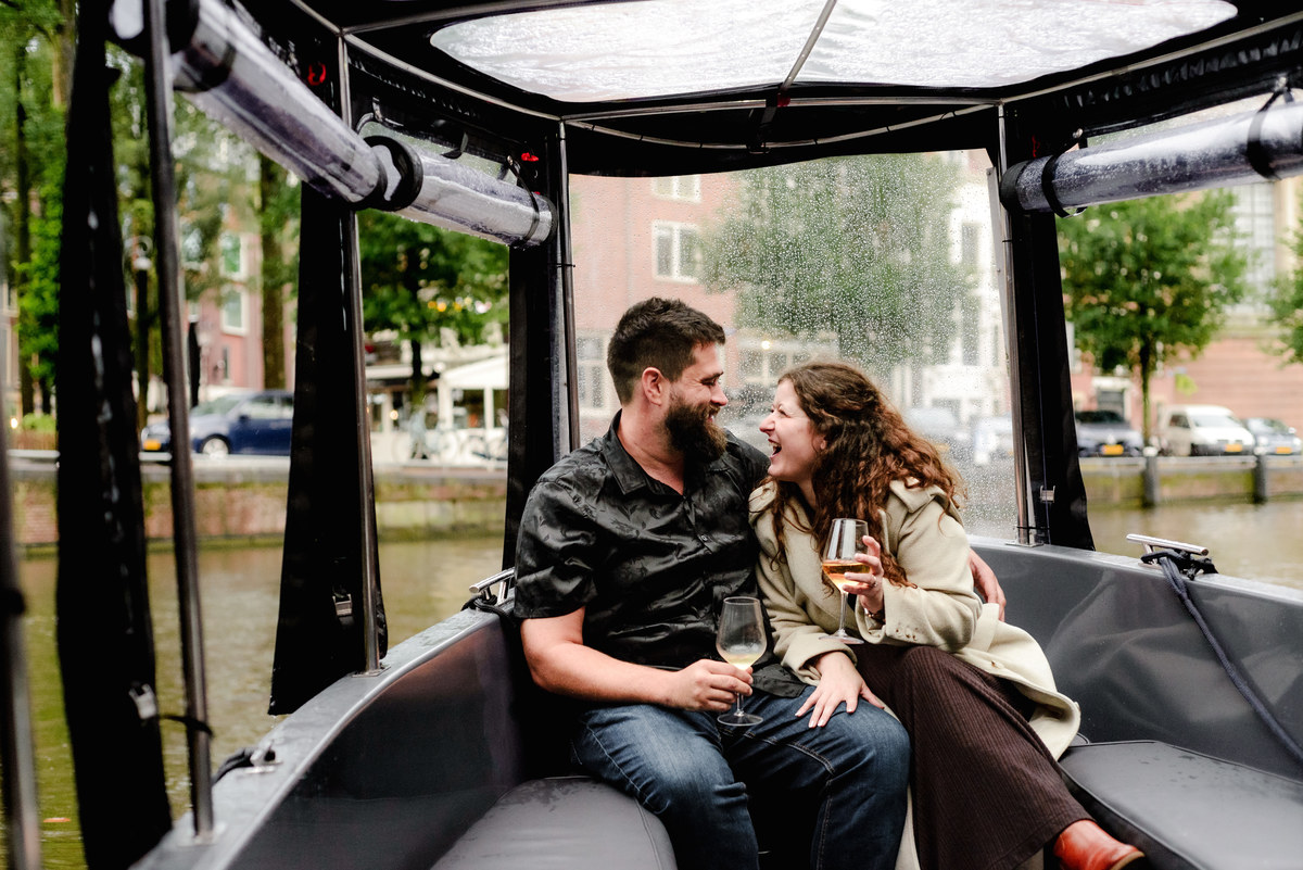 Behind-the-scenes shot of the photographer capturing a proposal from the boat’s deck, blending into the crew