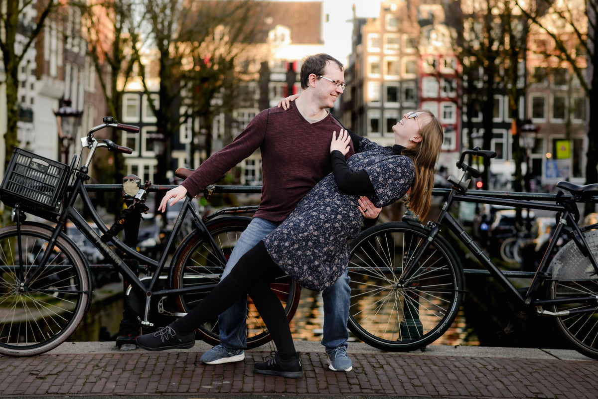 Playful dance pose on a bridge in Amsterdam’s canal district – perfect for couples who want to add personality to their anniversary session.

