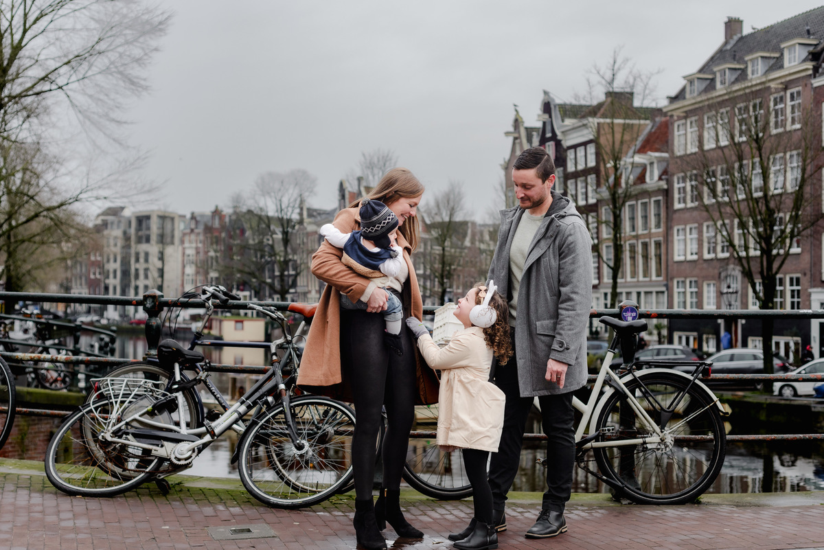 Group hug, Amsterdam edition — warmth and joy radiate from this sweet family moment surrounded by city charm.