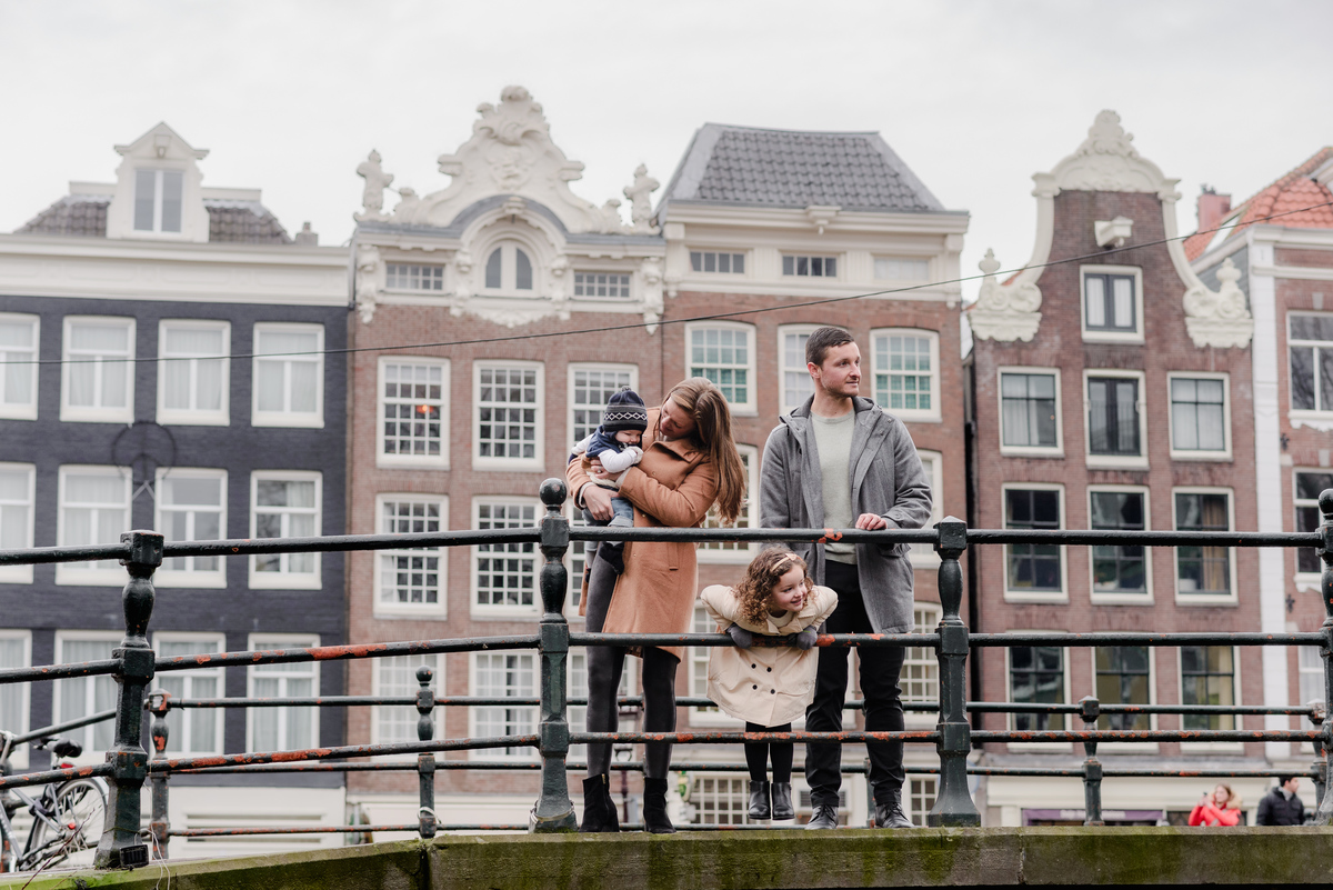 Sidewalk smiles and cozy coats—this casual walk becomes a picture-perfect memory among the canals.