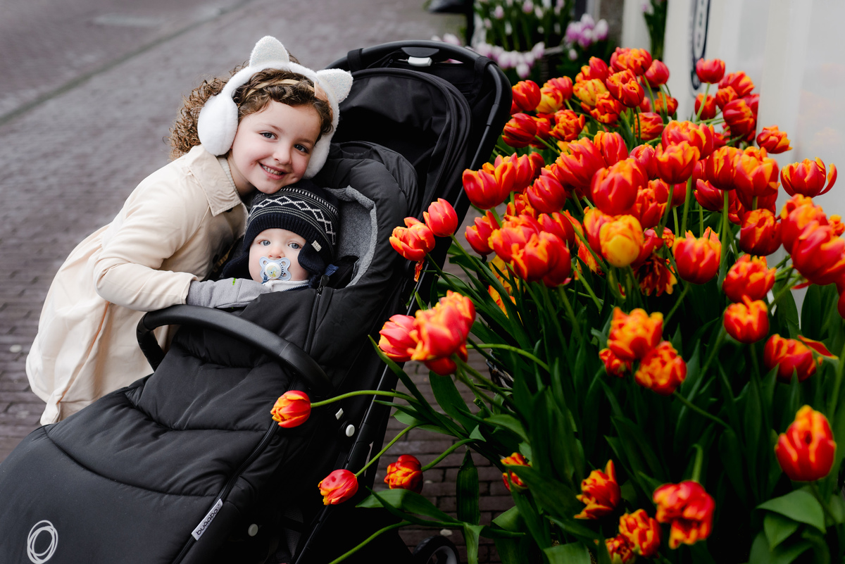 A close-up of spring’s magic in January, vivid tulips, bundled babes, and sibling love captured in one perfect frame.