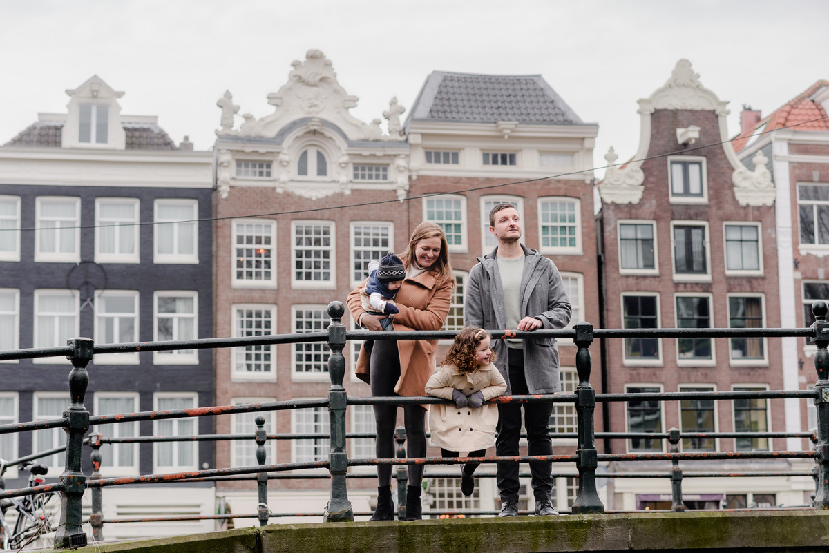Happy and relaxed, the family takes a winter stroll through Amsterdam’s leafy streets, captured in mid-conversation.