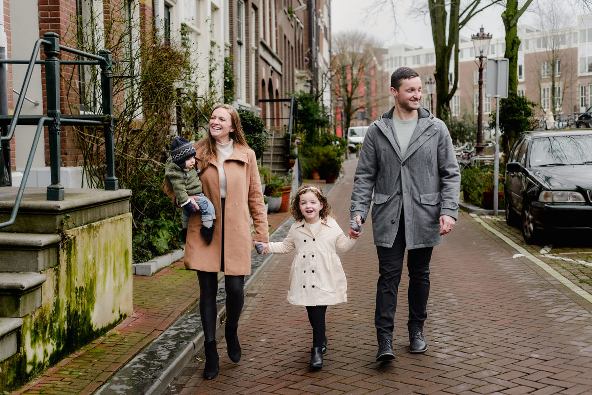 Sidewalk smiles and cozy coats—this casual walk becomes a picture-perfect memory among the canals.