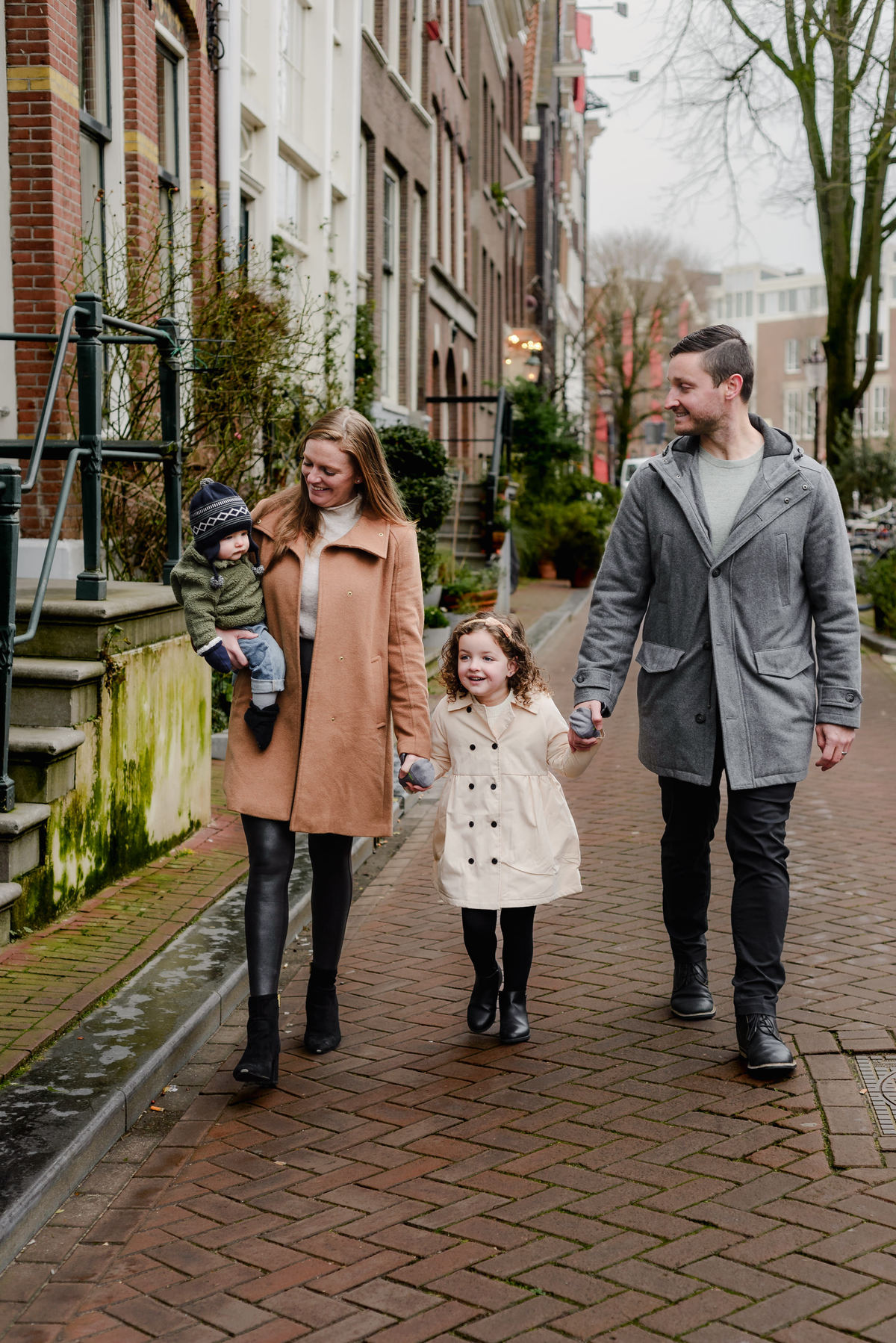 Walking hand-in-hand, the family moves in perfect sync, their faces lit up with connection and ease.