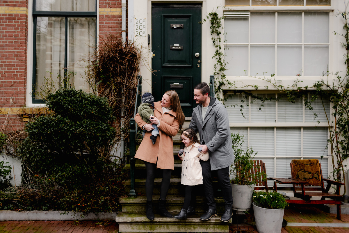 Sweet family moment on a stoop, pausing mid-adventure to soak in the scene and each other’s company.