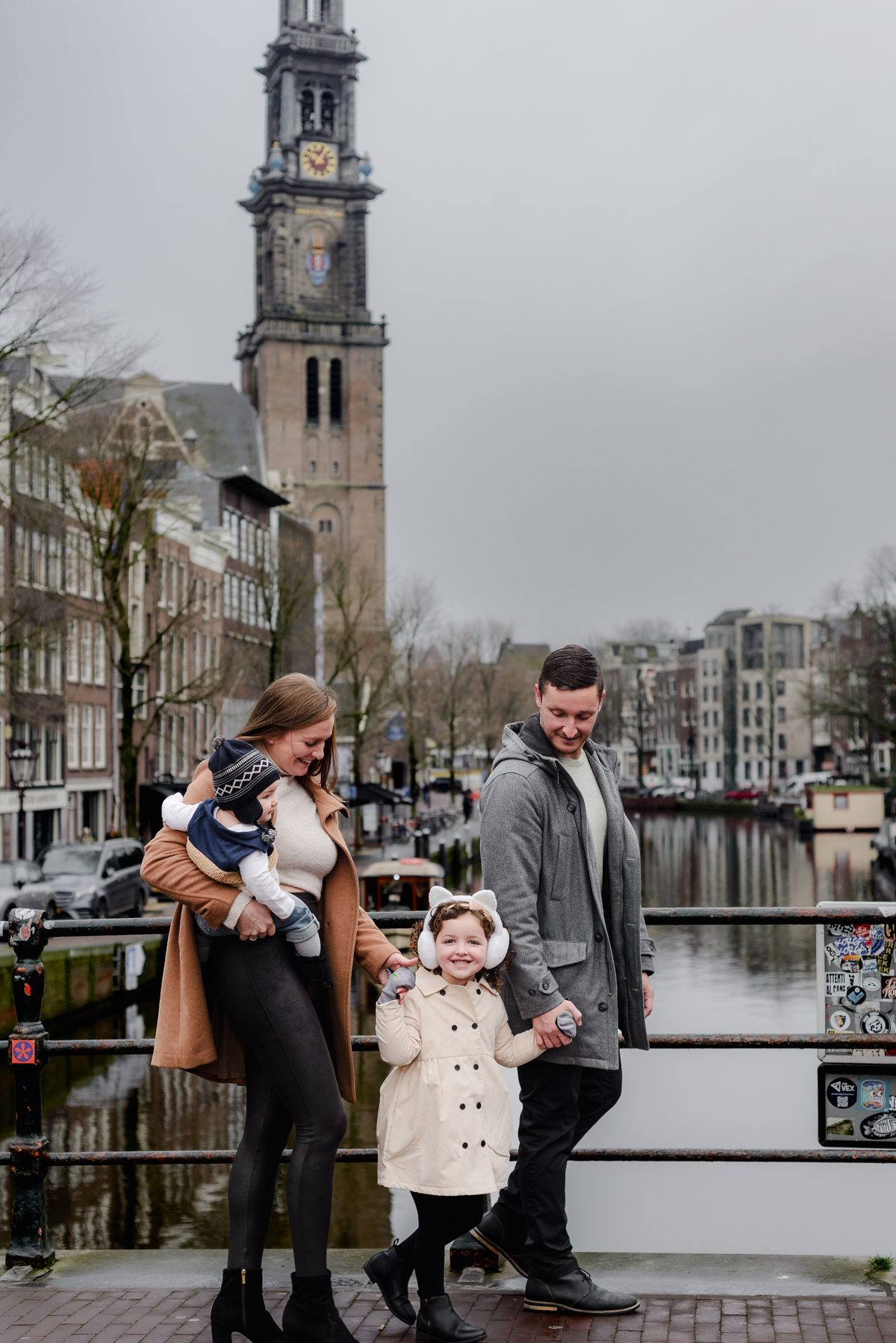 The Westerkerk tower watches over as the family strolls hand in hand, a timeless snapshot of connection and culture.