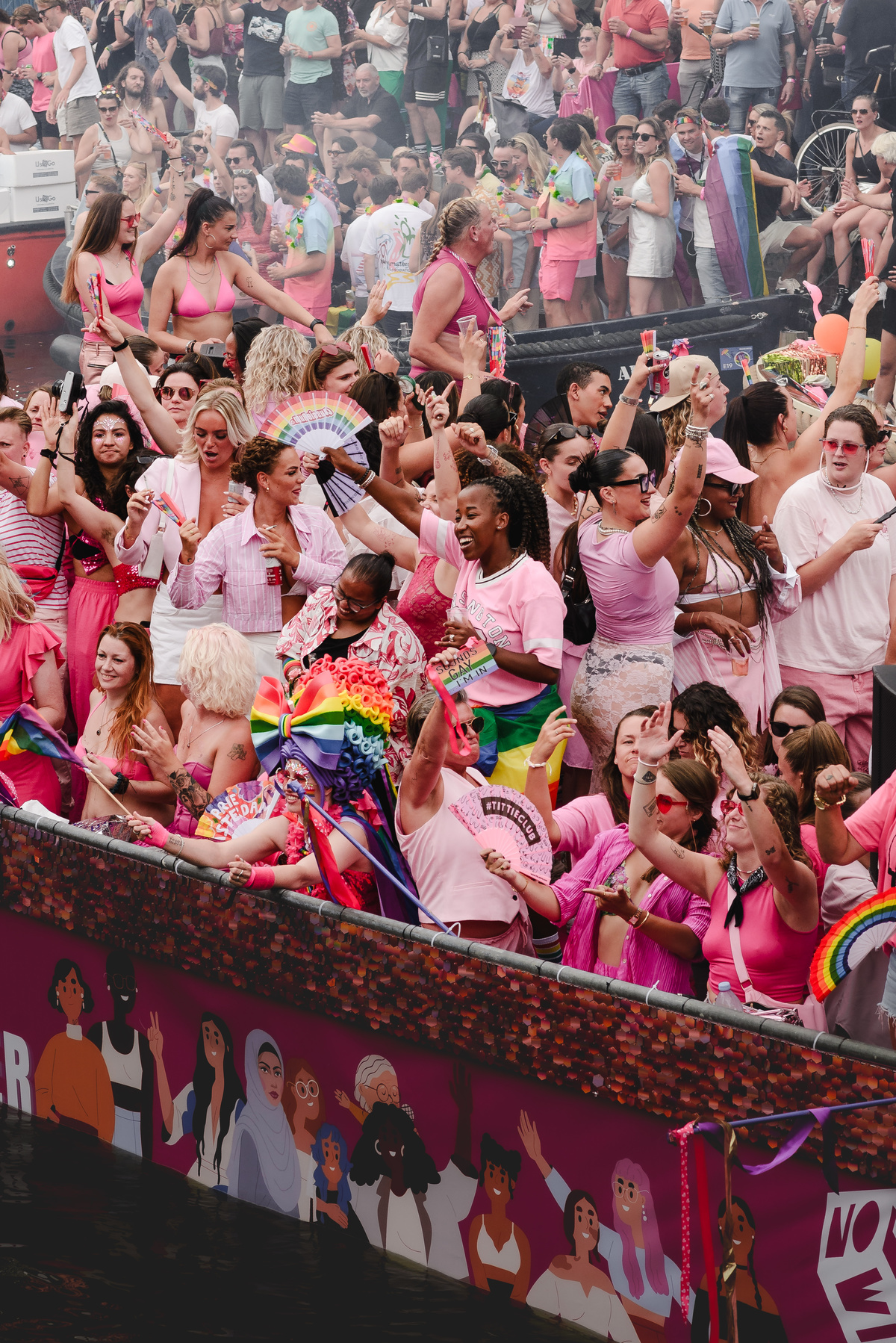 Wide-angle view of boats arriving at the canal parade, showing energy and movement in the scene.