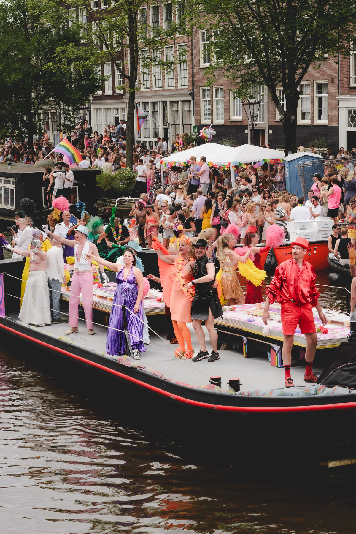 Wide-angle view of boats arriving at the canal parade, showing energy and movement in the scene.