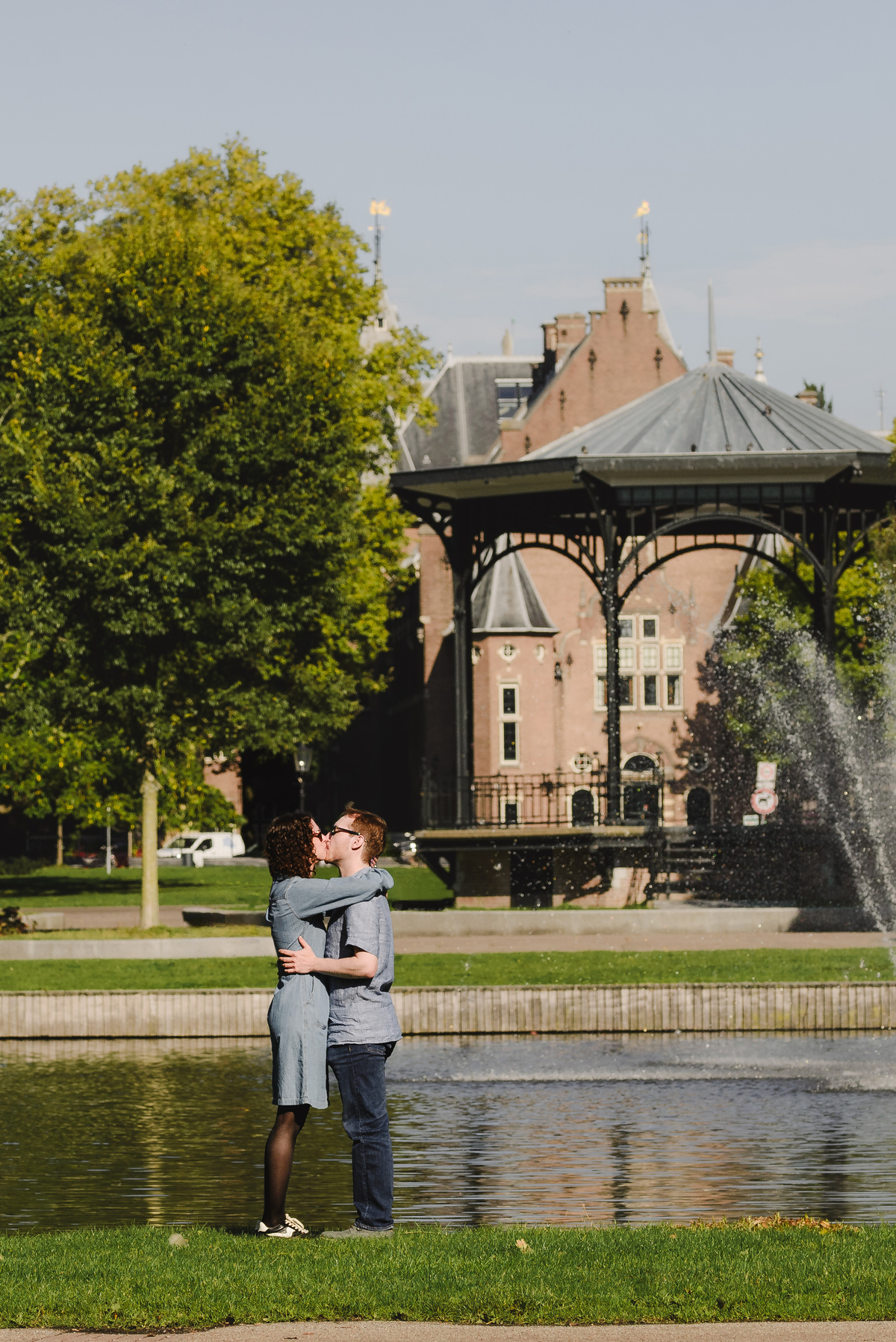Couple in front of Oosterpark gazebo. Surprise engagement proposal in Amsterdam, The Netherlands