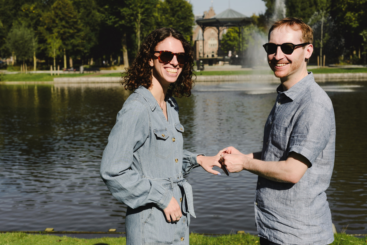 Surprise engagement proposal in Amsterdam, The Netherlands. Man is putting the ring after she said yes to the proposal