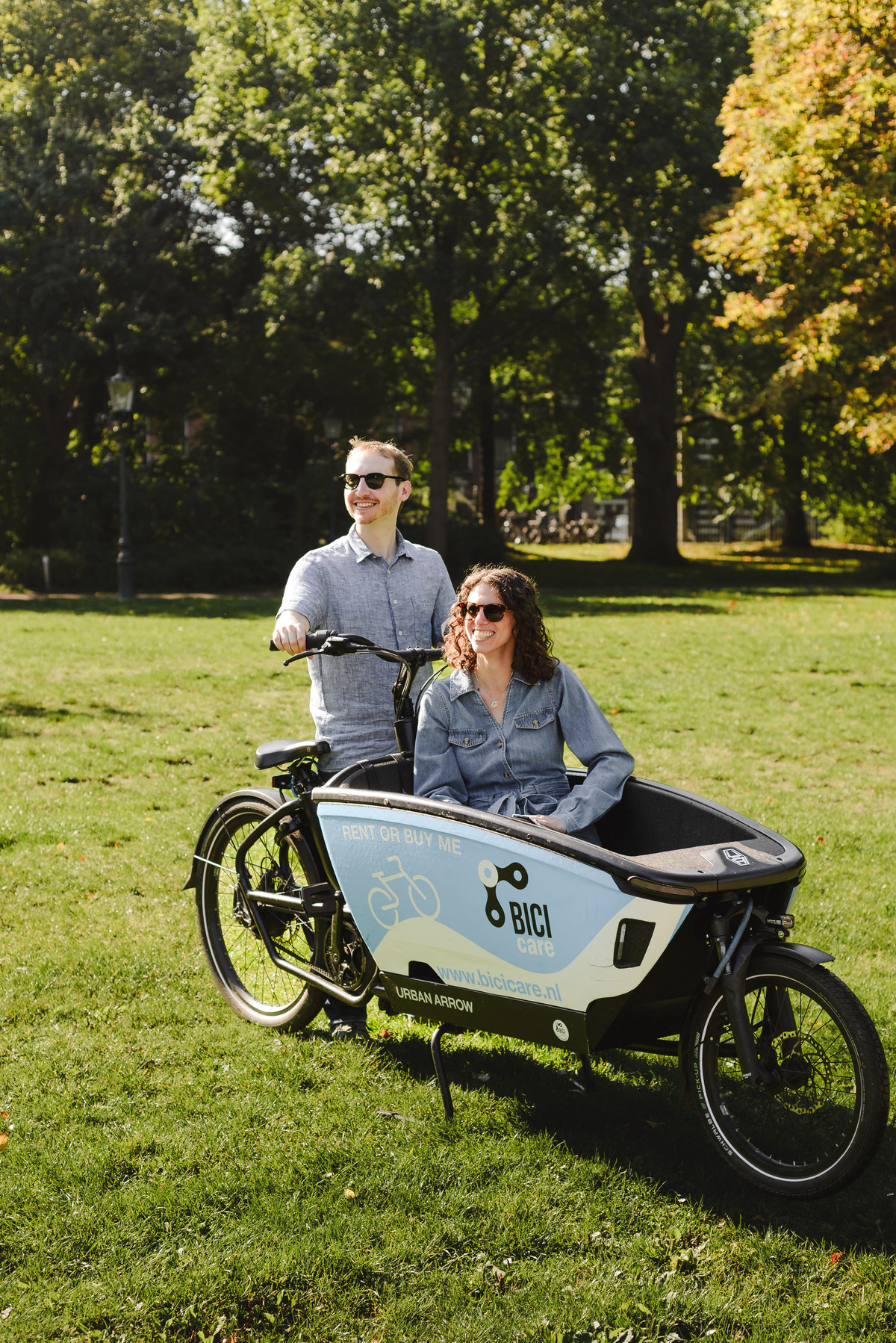 Couple on a cargo bike urban arrow in Amsterdam, The Netherlands