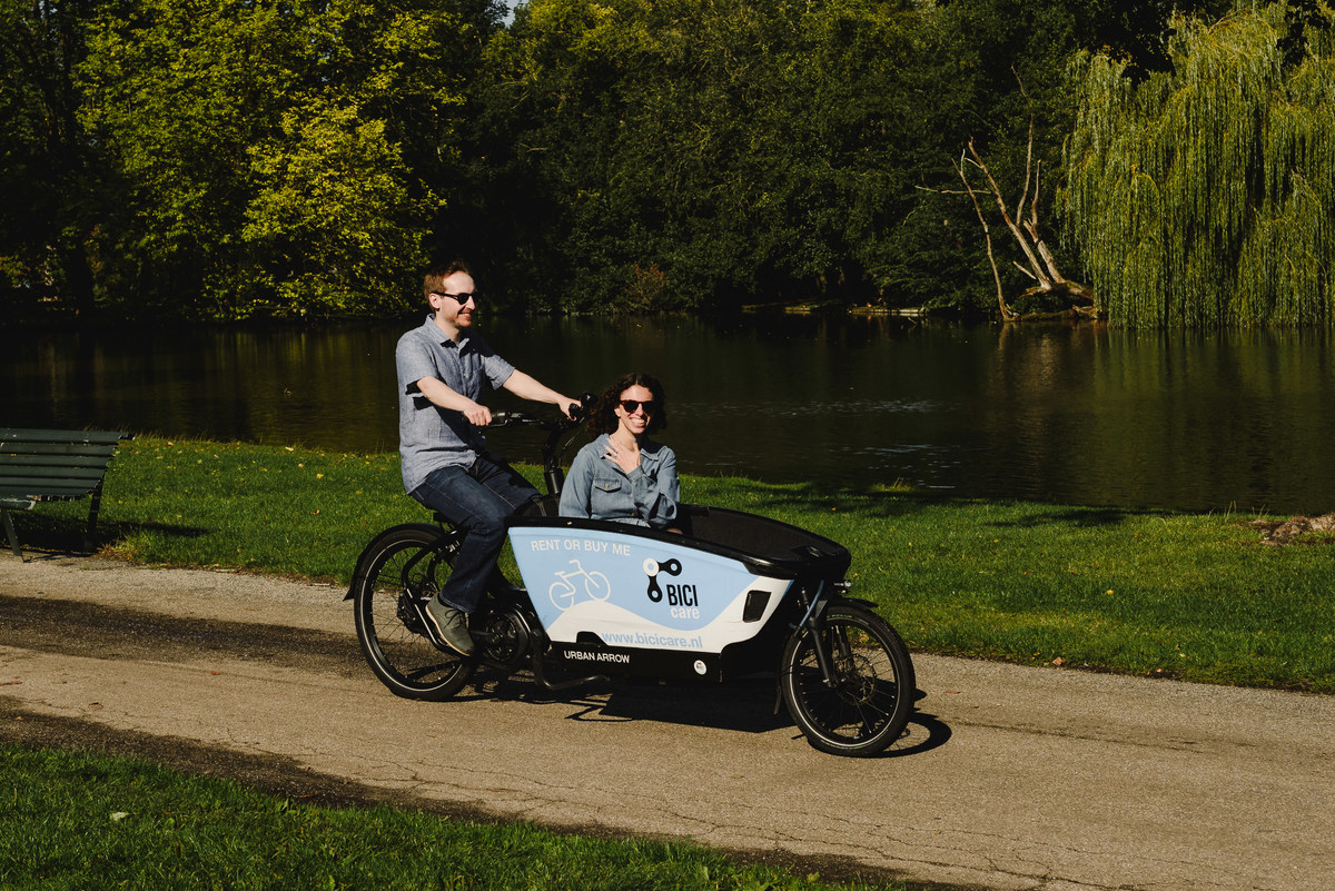Couple on a cargo bike urban arrow in Amsterdam, The Netherlands