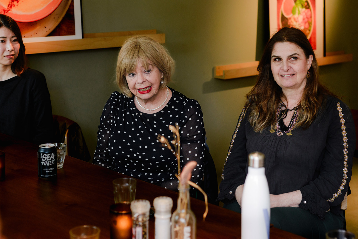 Intimate brunch event in Amsterdam with women seated around a table, photographed during a small community gathering organized by Amsterdam International Women.