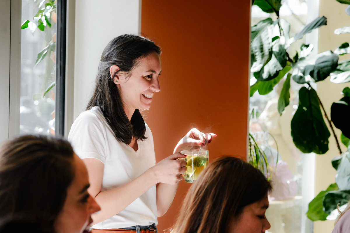 Candid moment of a guest smiling during a relaxed brunch event in Amsterdam.