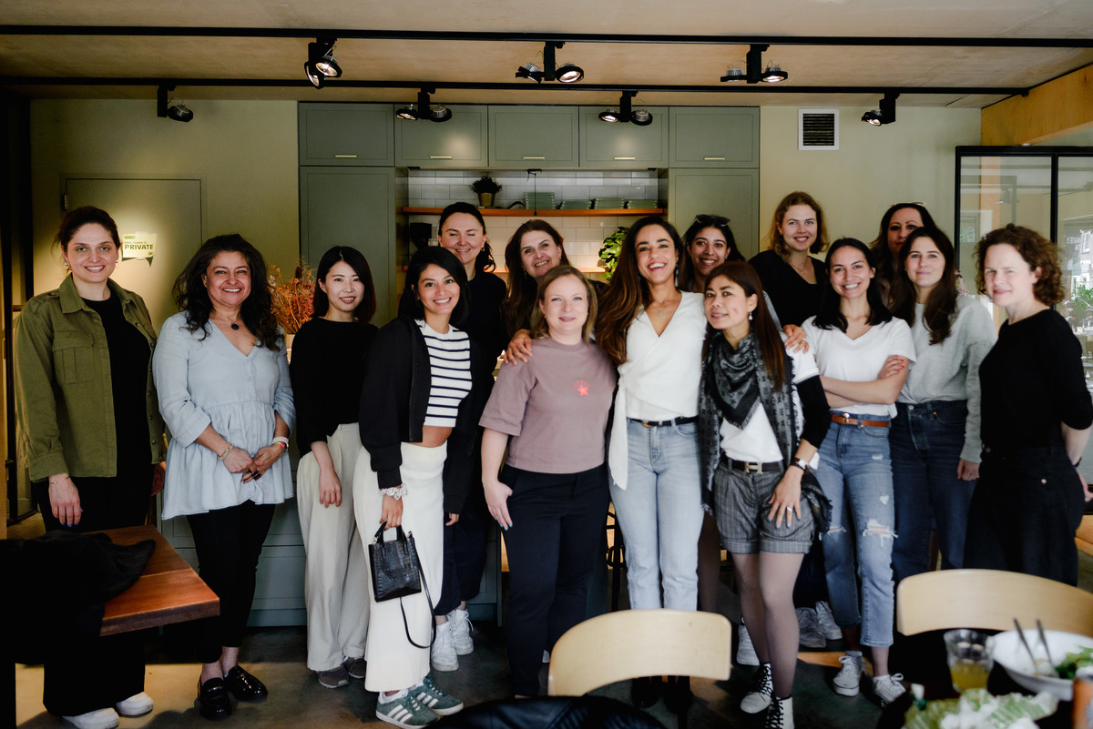 Group portrait of women at a small community brunch event in Amsterdam, photographed indoors by an event photographer