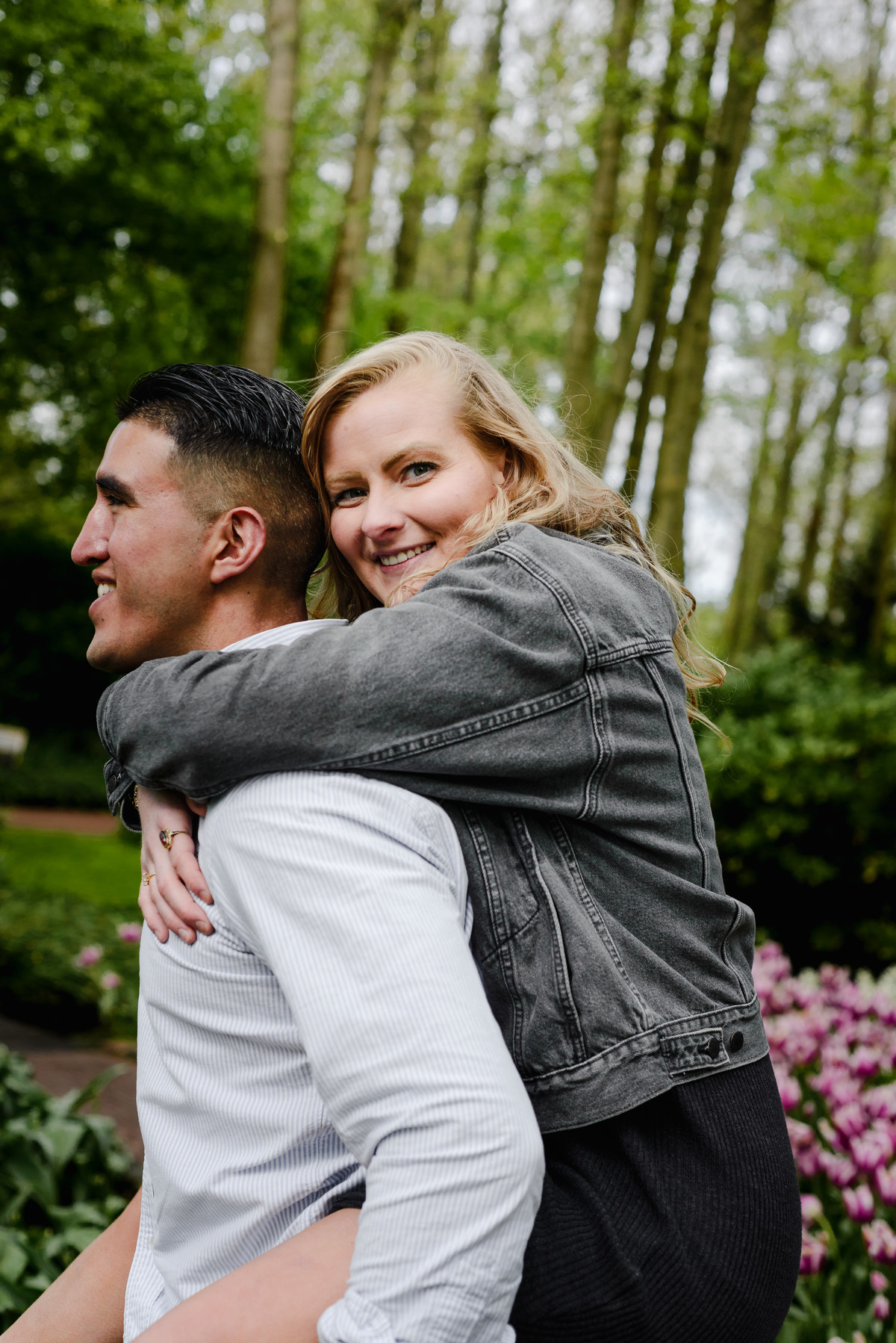 Newly engaged couple laughing together in spring flower garden at Keukenhof