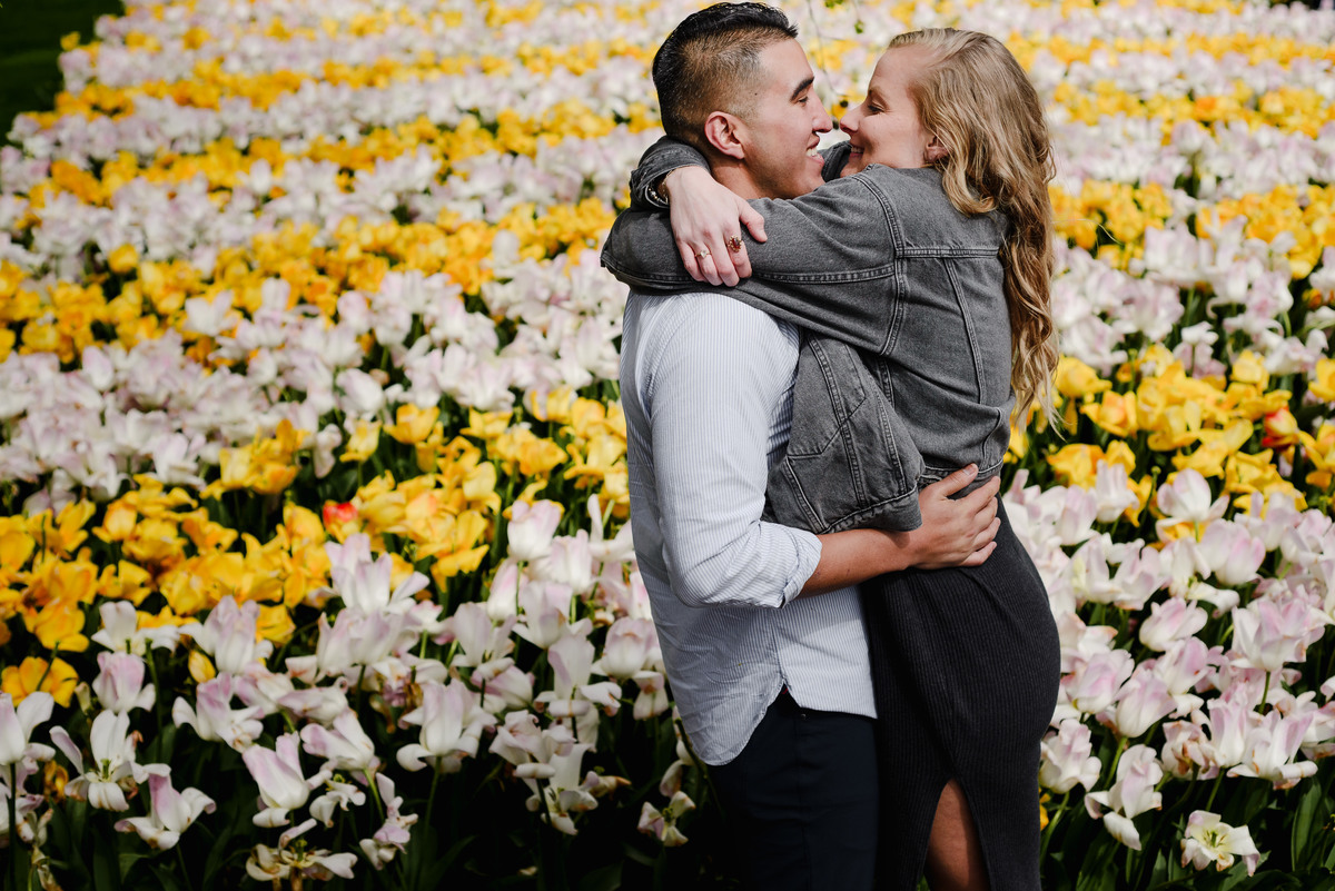 Couple embracing in colorful tulip garden during spring in the Netherlands