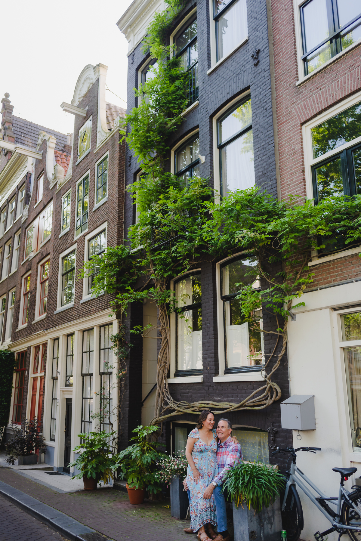 Couple standing on staircase near Amsterdam canal