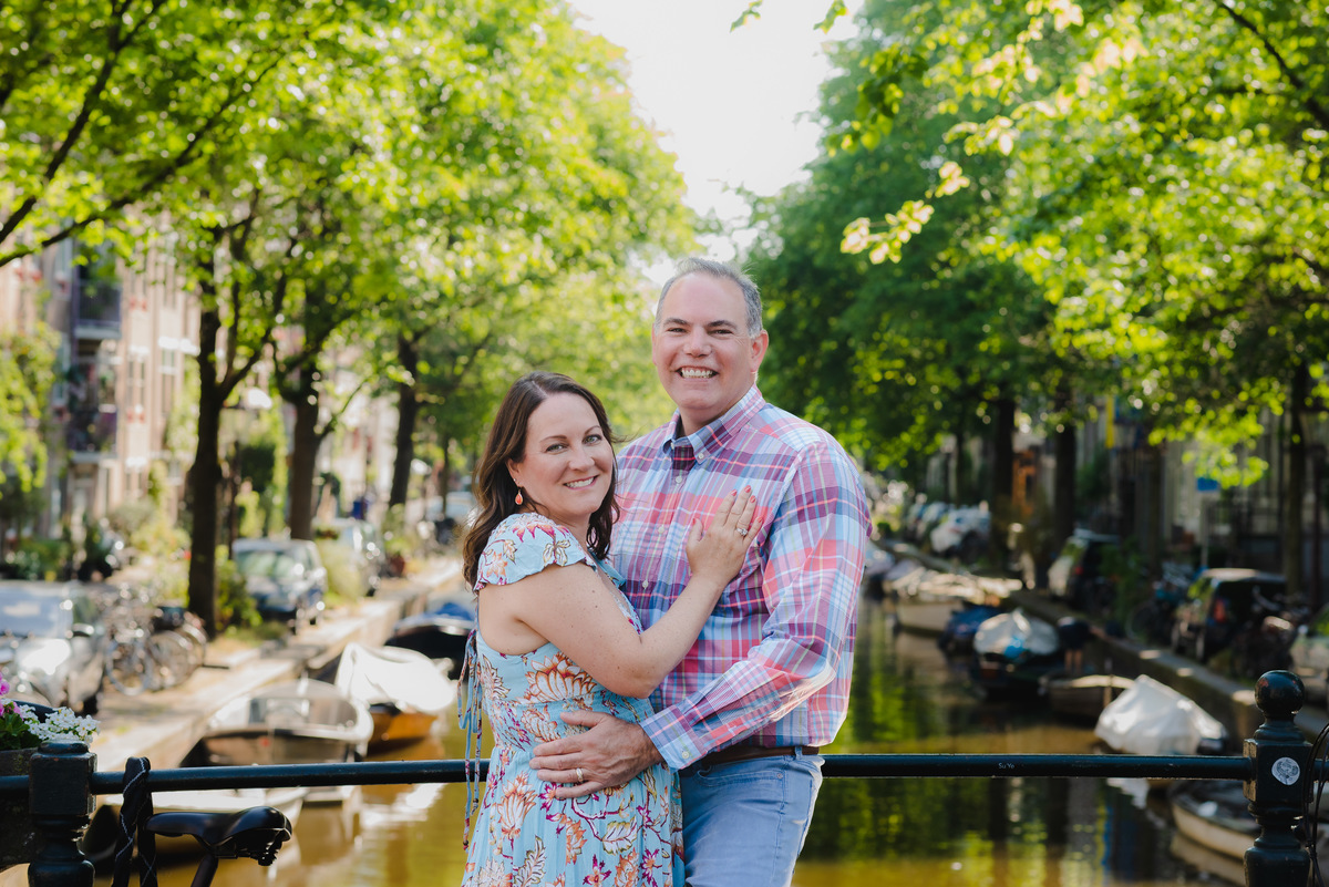 couple standing next to a canal bridge in amsterdam, Jordaan district, during a summer photo session