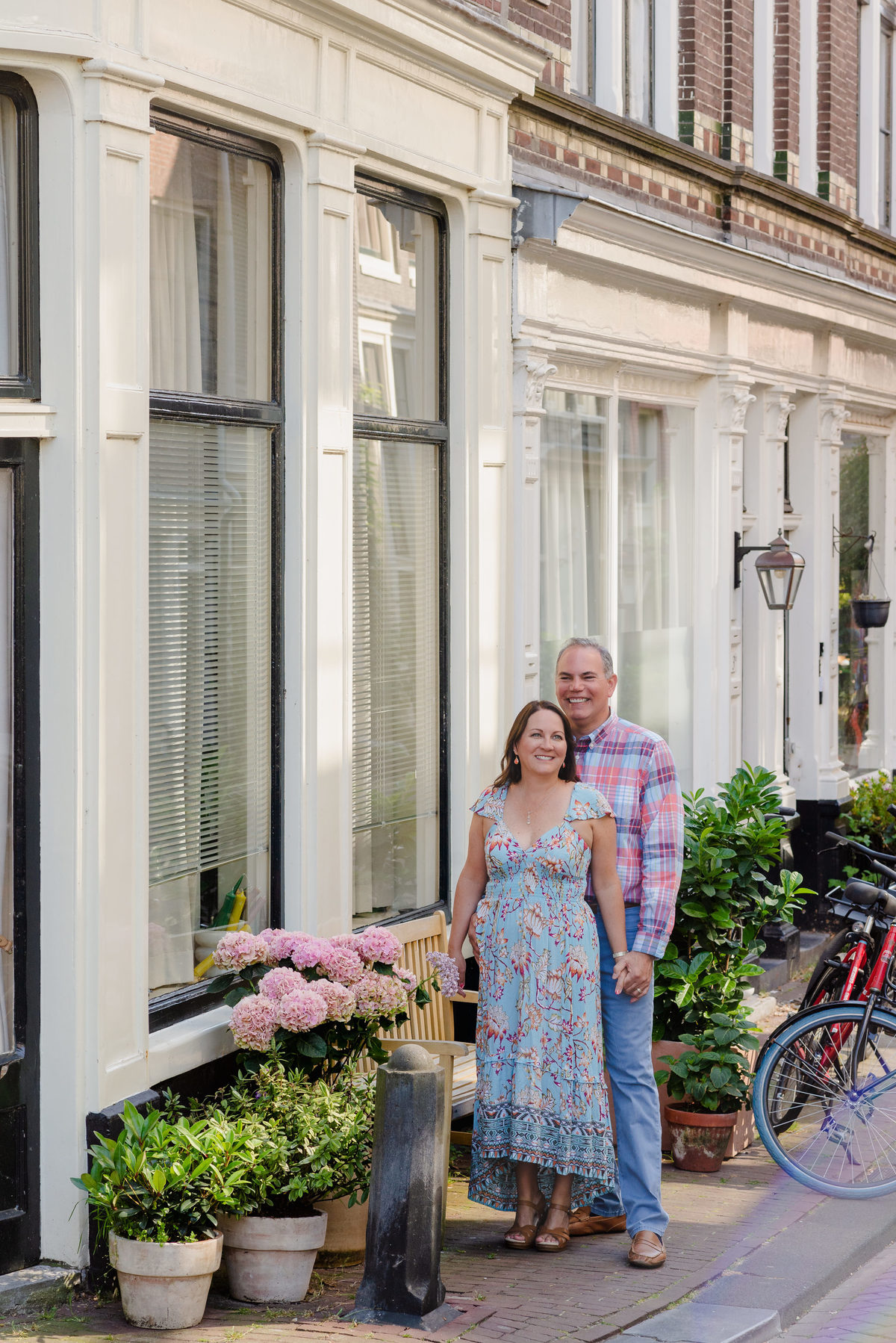 Anniversary couple standing by Amsterdam canal in summer