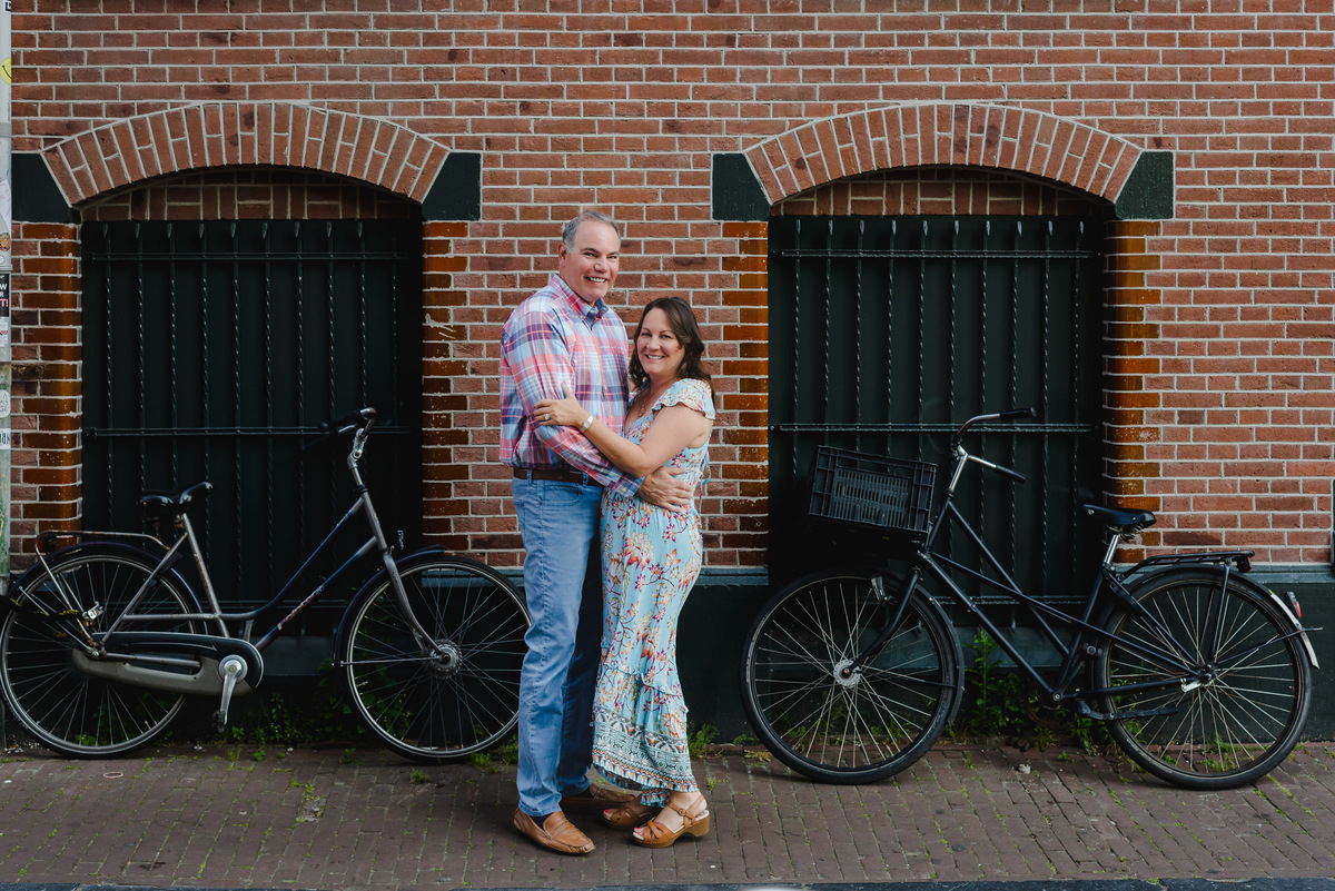 Anniversary couple standing by Amsterdam canal in summer