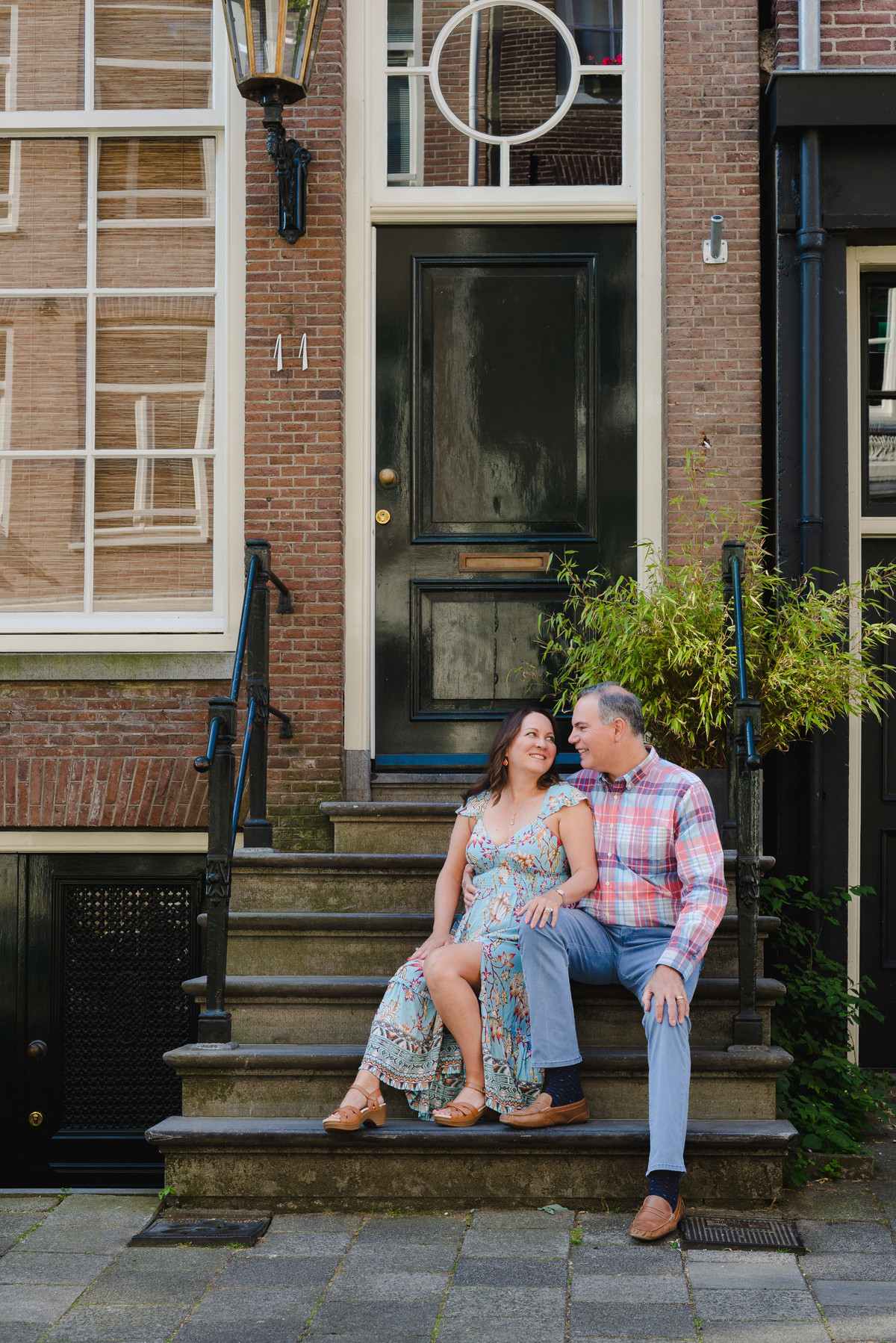 Anniversary photo on canal bridge in Amsterdam