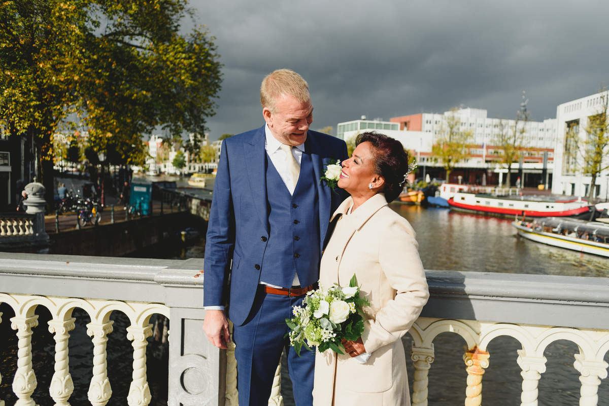 Couple in front of the Amstel before civil wedding ceremony in Amsterdam